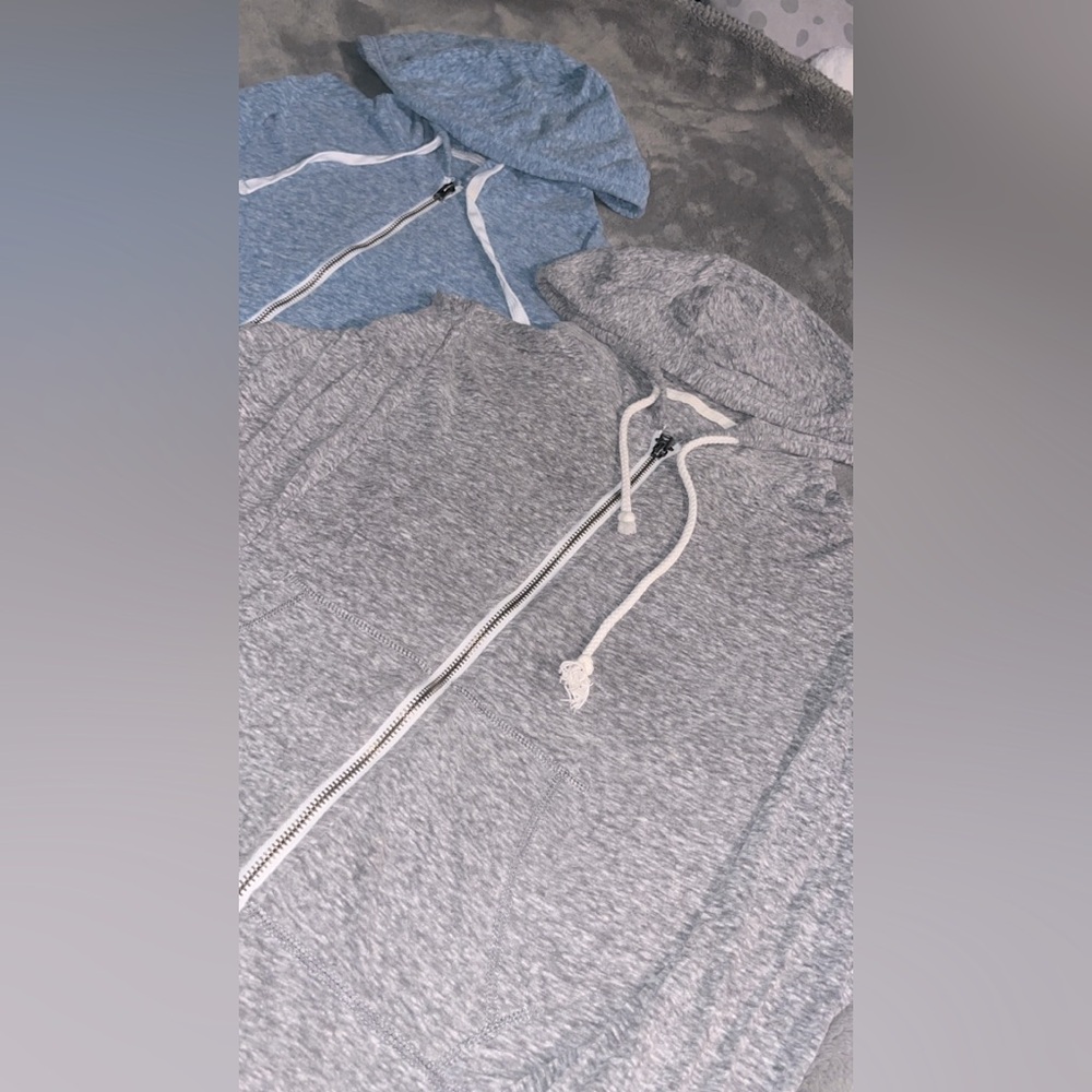 A bundle of two thin hooded sweaters